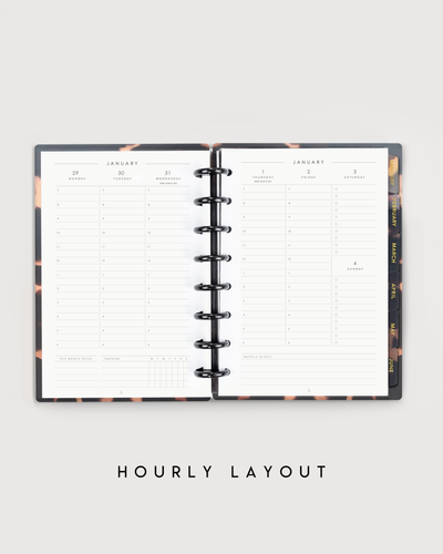 Open planner with hourly layout on a light gray background